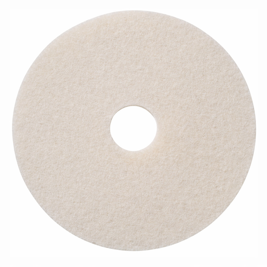 Round beige cleaning pad with a central hole on a white background
