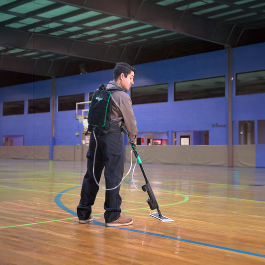 Person cleaning a basketball court with Excella Floor Finishing Kit