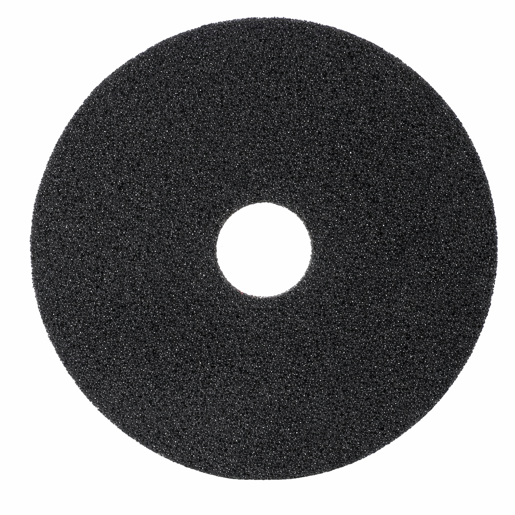 Black foam pad with a central hole on a white background